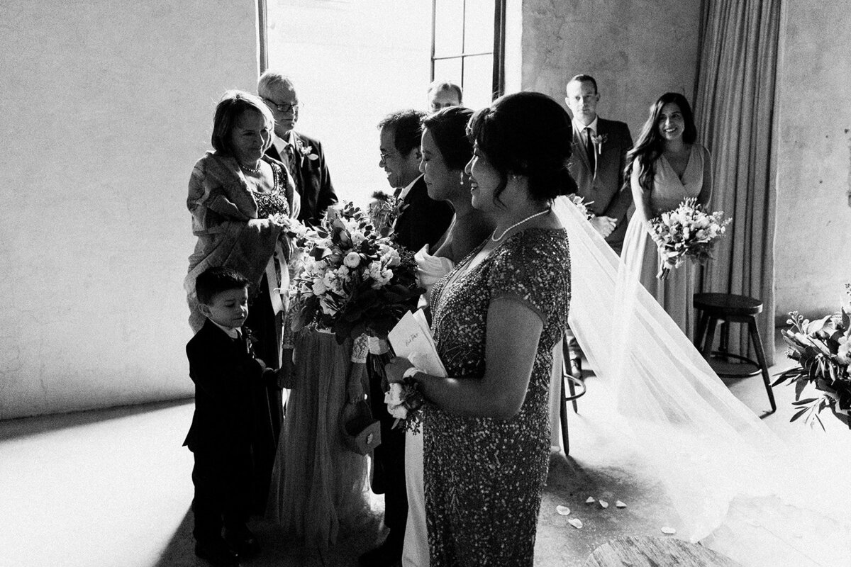 side view of bride and her family at the altar