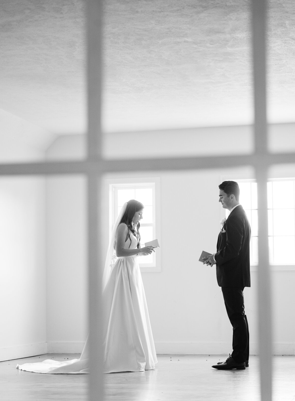 a bride and groom share their first look and private vows inside a space at Post Family Farm