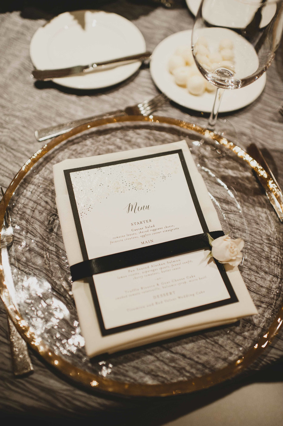 Small touches like a black ribbon around the menu and a rose at each place setting welcome your guests.