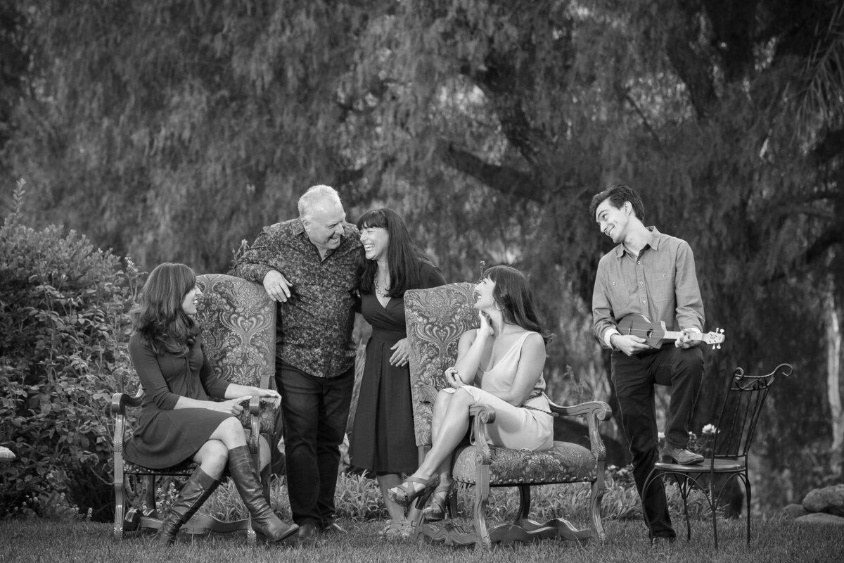 Black and white photo of a family all gather together smiling