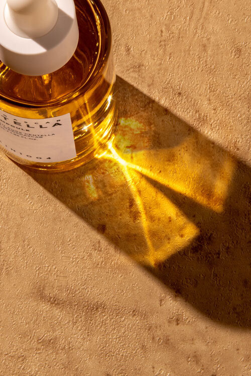 Charlottesville Virginia product photography of skincare oil with golden glow and moody highlights, styled for luxury beauty brands.