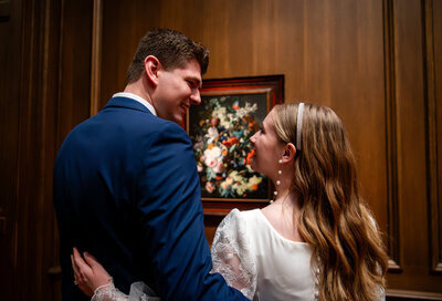 Wedding couple embrace and look into one another's eyes in Leesburg VA wedding