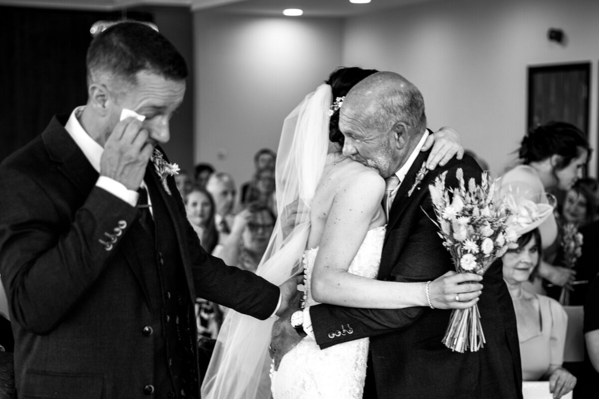 groom wiping his tears