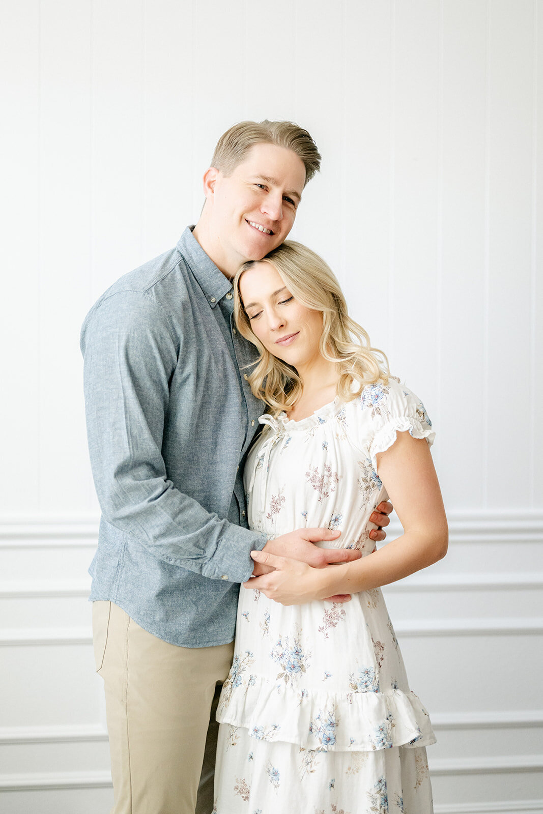 Couple hugs during in home lifestyle family session by Baton Rouge photographer.