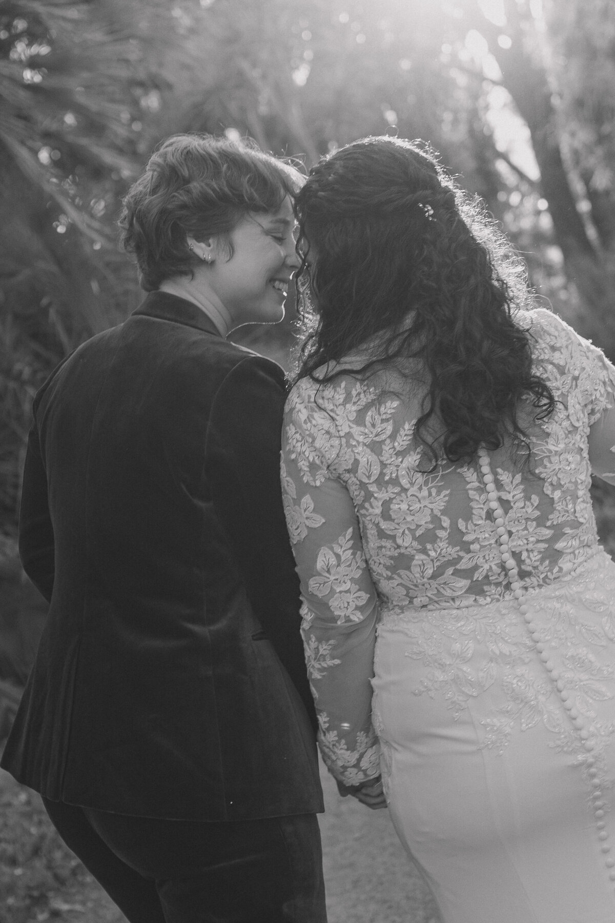 Bride and bride share an intimate moment smiling and gazing into each others eyes after thier wedding ceremony at Ruth Bancroft Botanical Garden