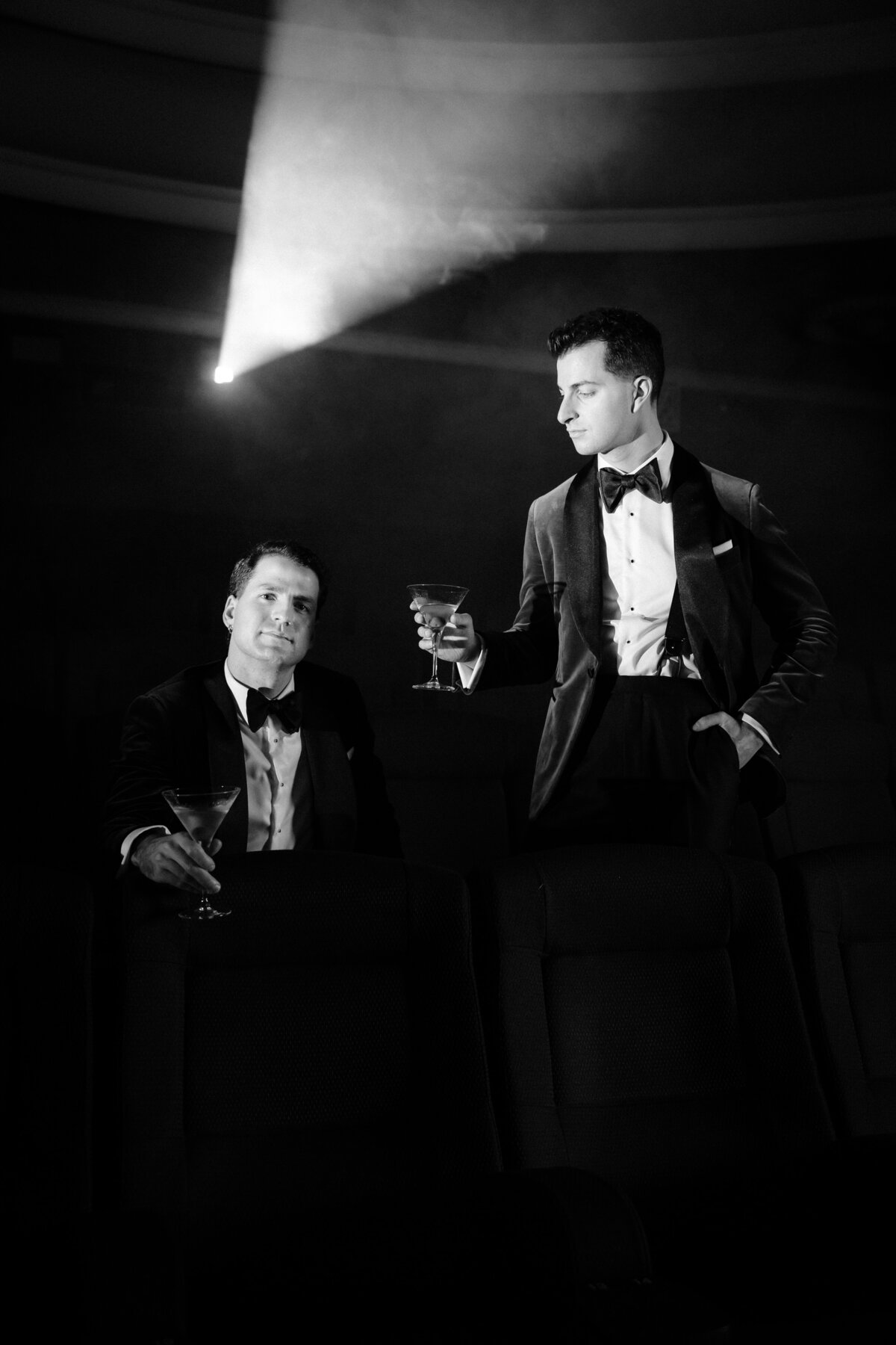 Black and white image of two grooms posing  for their photo session pre-wedding ceremony.