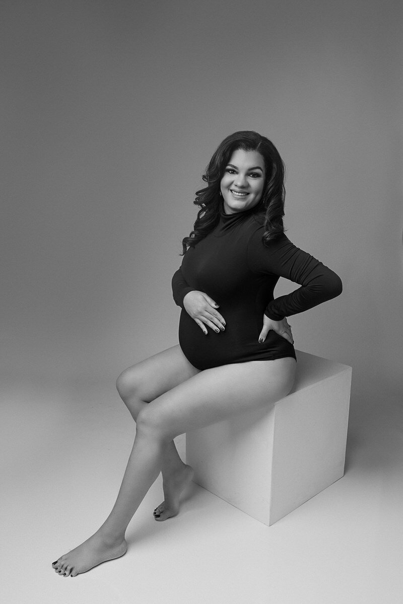 pregnant woman sitting on box