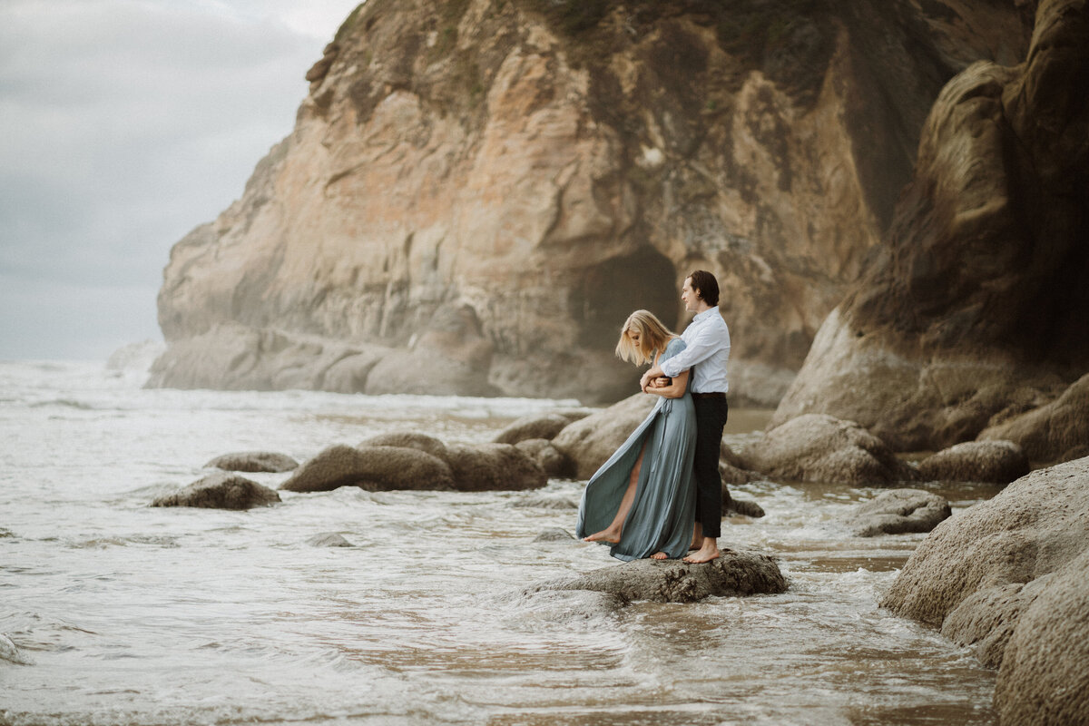 Couple standing in the water during Oregon coast engagement session