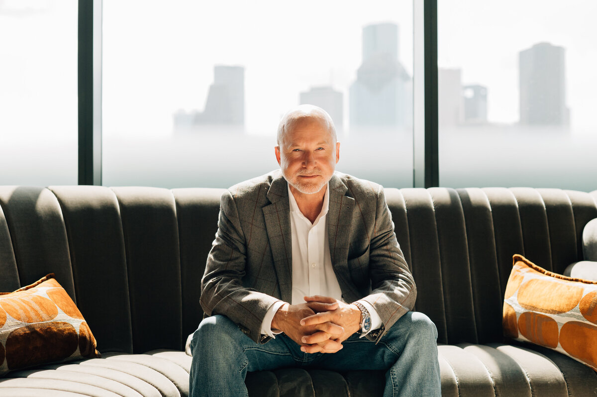 Office portrait with bookshelf background by Houston commercial photographer