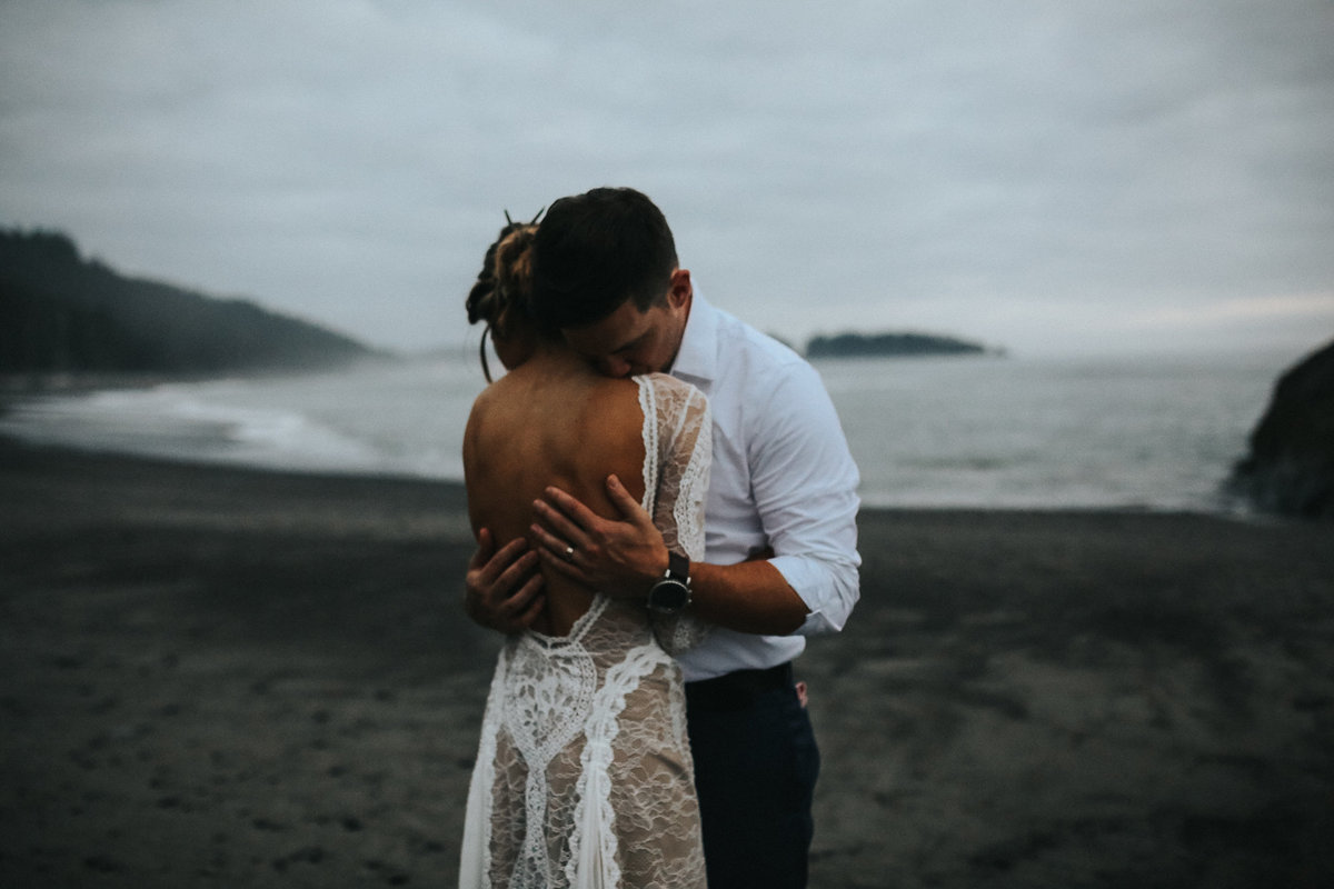 Bride and groom portrait of an elopement wedding in La Push  Washington on the moody beaches of Rialto Beach.