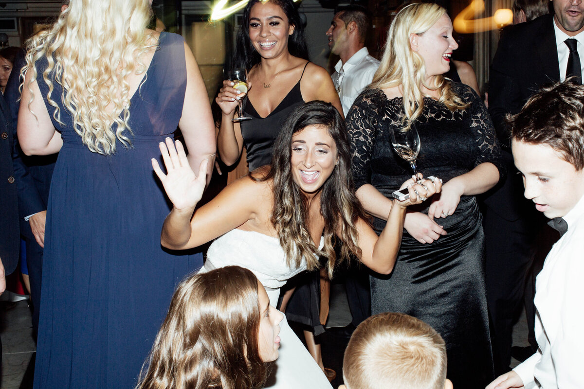 Bride dancing at wedding reception.