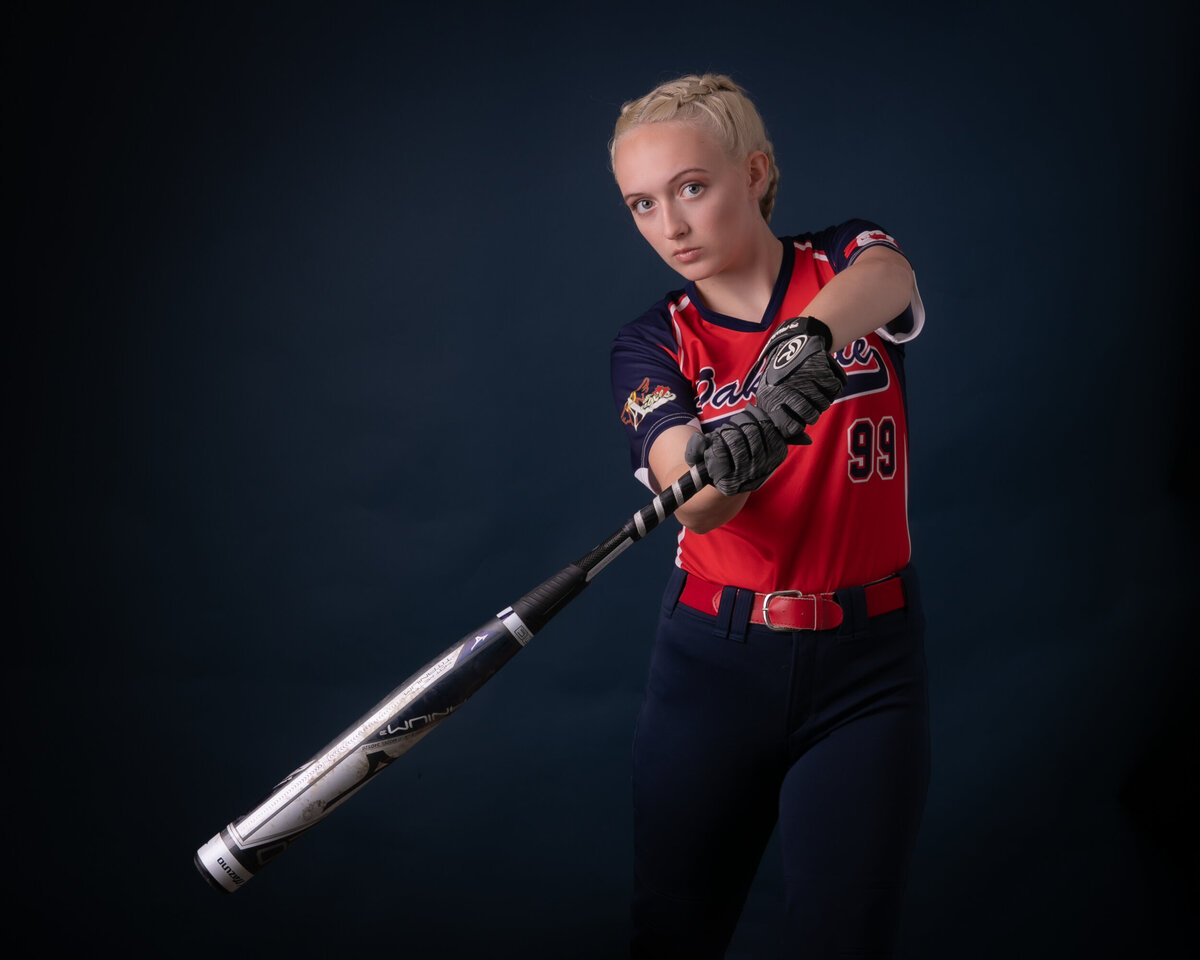 Female Baseball player swinging a bat. 