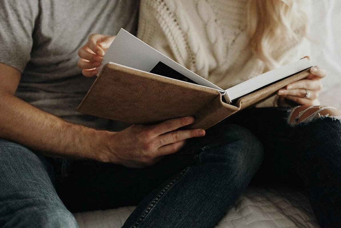 urban-row-photo-couple-holding-wedding-album