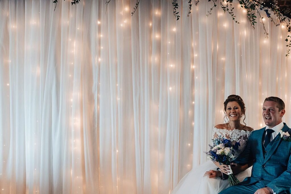 A bride and groom posing for a picture