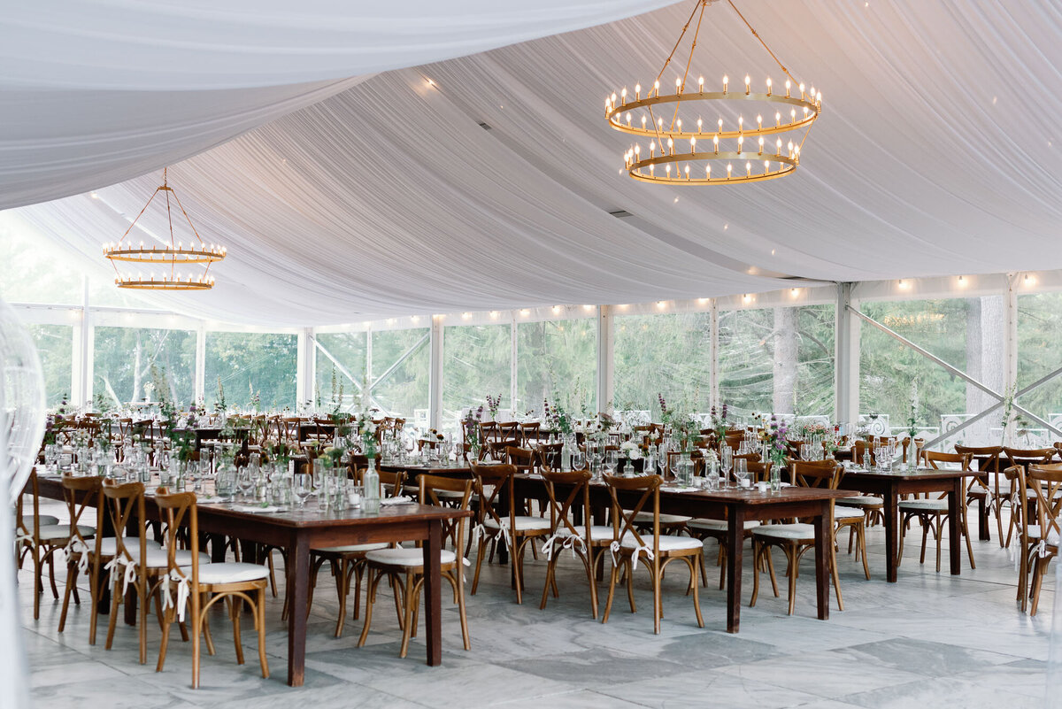 reception tent at wilburton inn  with banquet tables, glassware and chandeliers