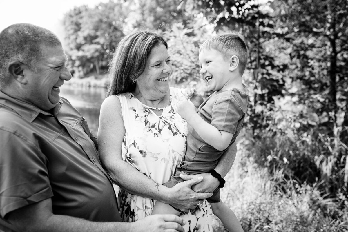 Grandparents embracing their grandchildren with big smiles during a warm family reunion photo session in the Eastern Townships