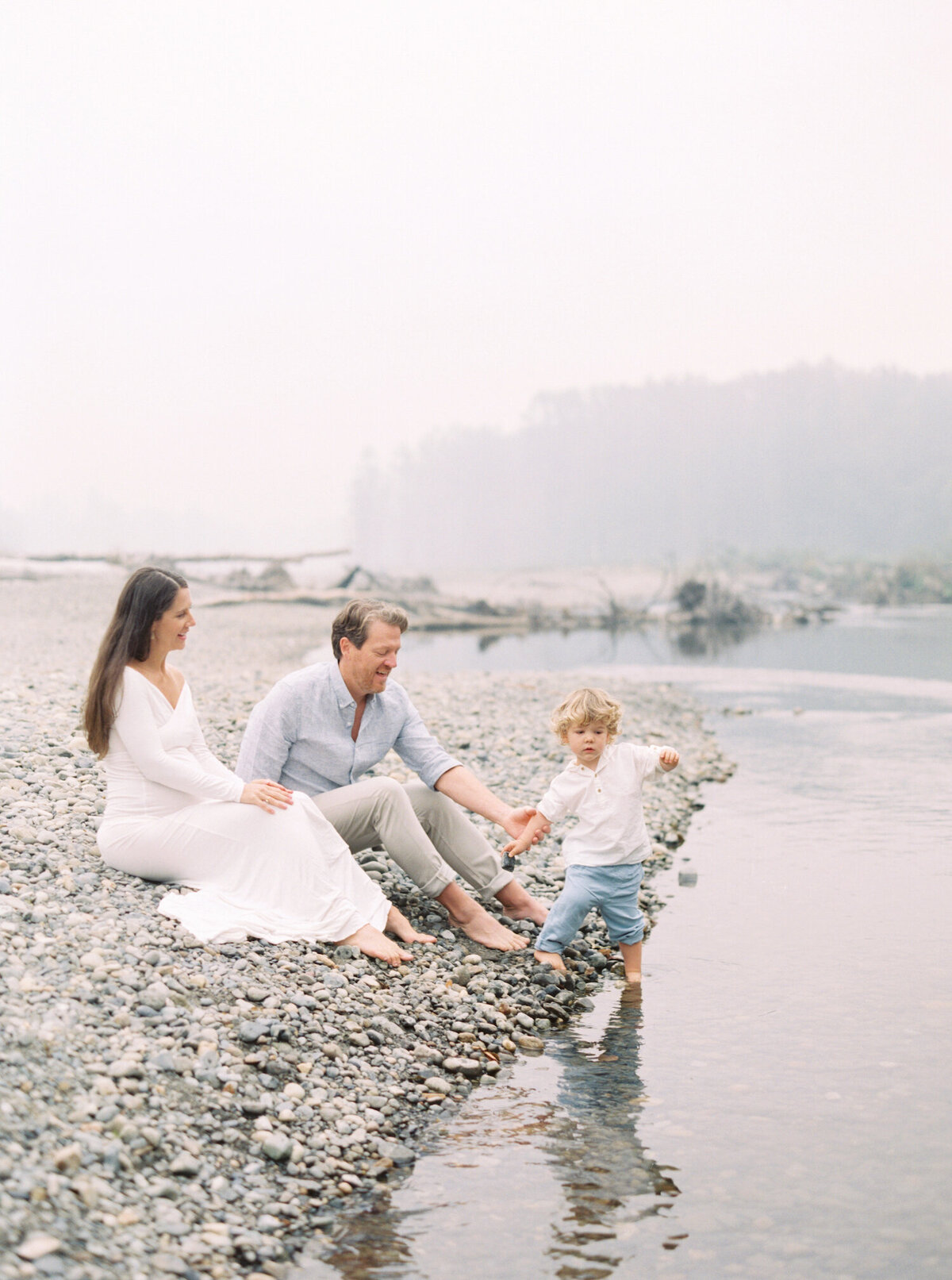 Seattle family photos captured on film at foggy river with blue and white outfits.