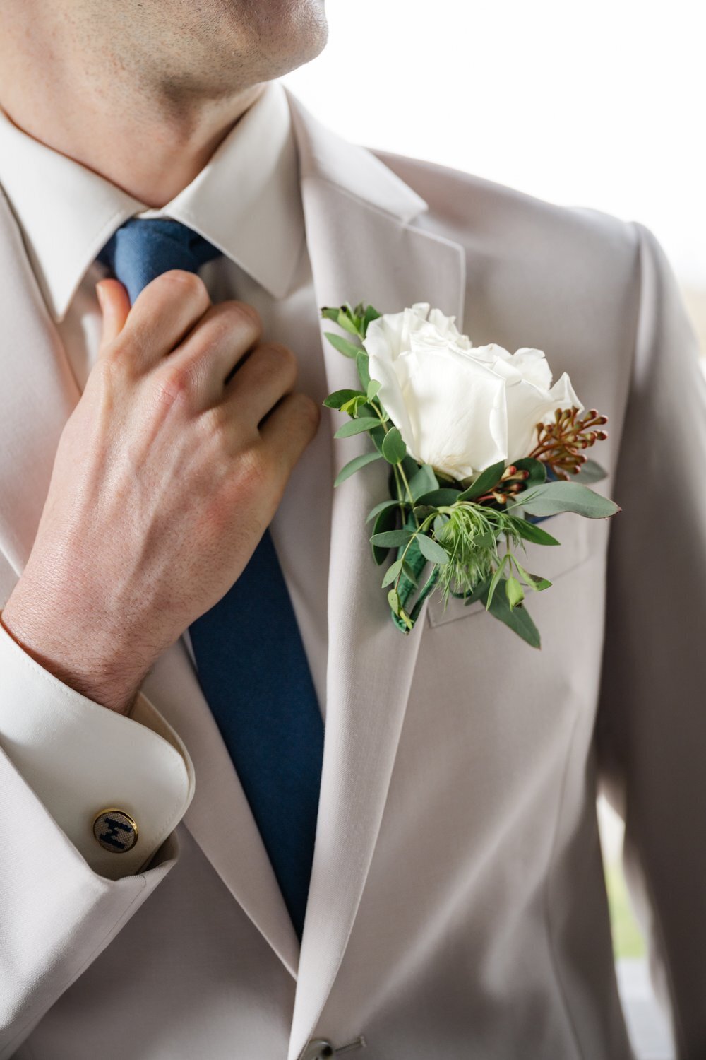 close up image of groom tie and suit