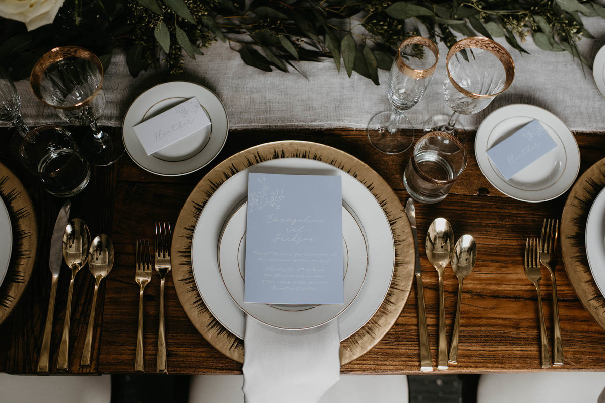 table setting for formal sit down dinner with gold utensils