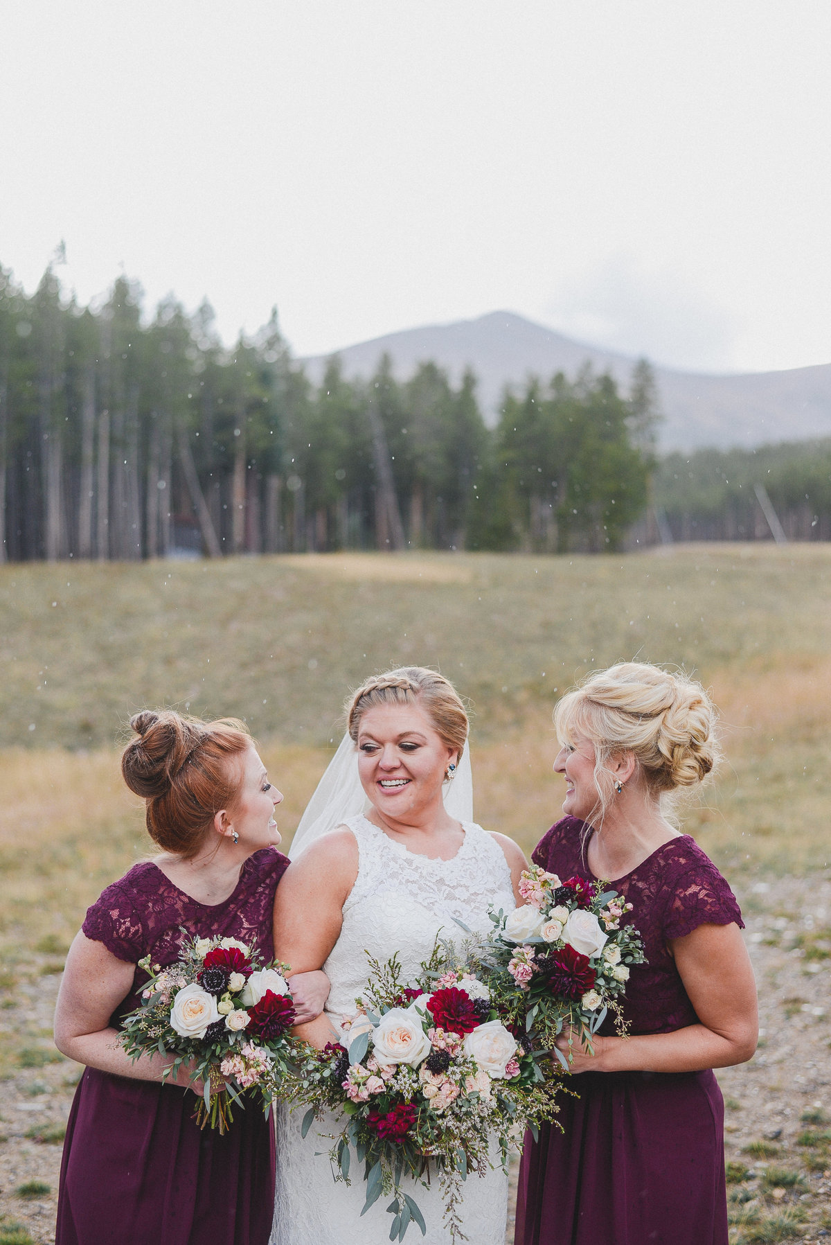 bridesmaid and bride wearing burgundy dresses