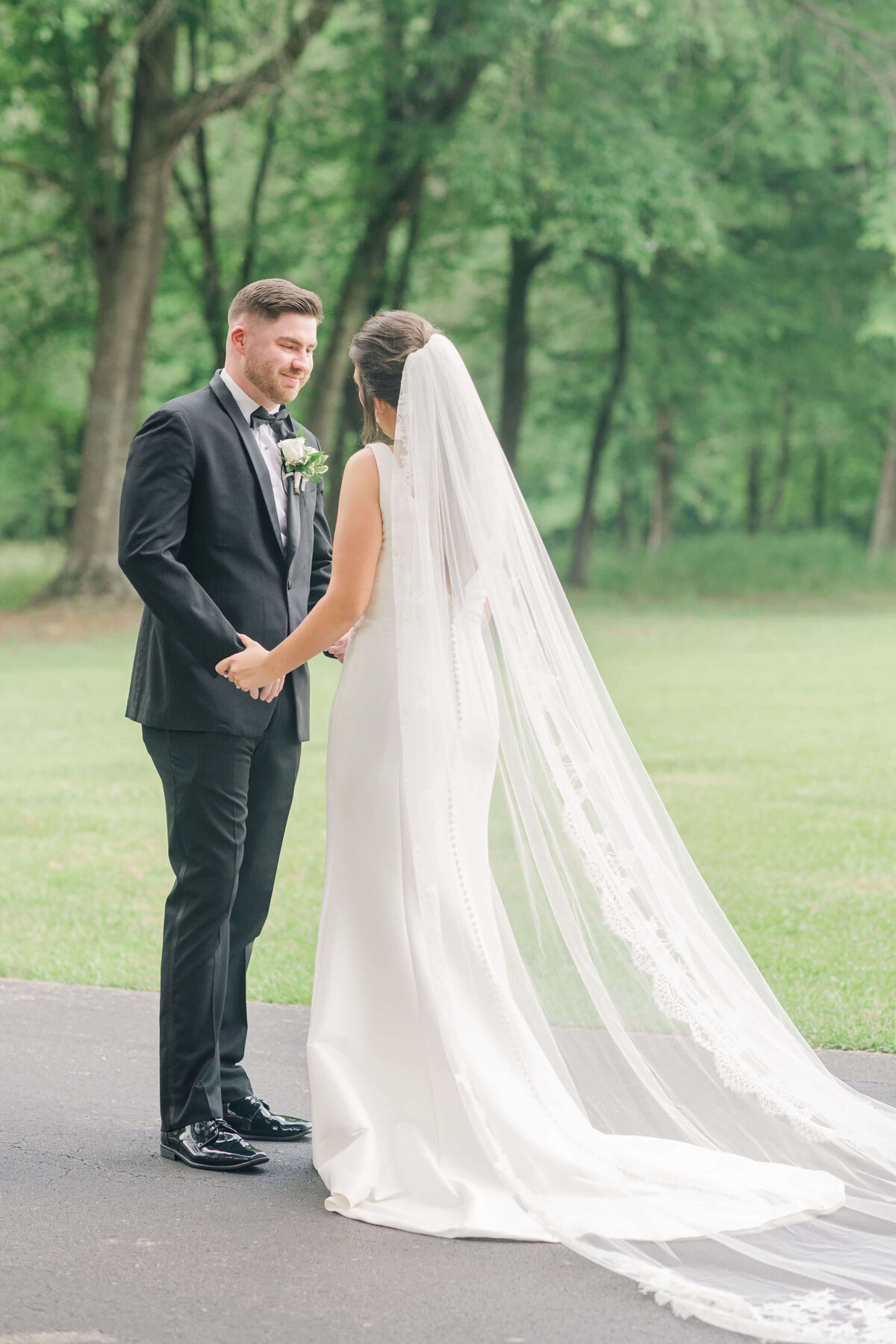 Groom seeing bride during first look photos