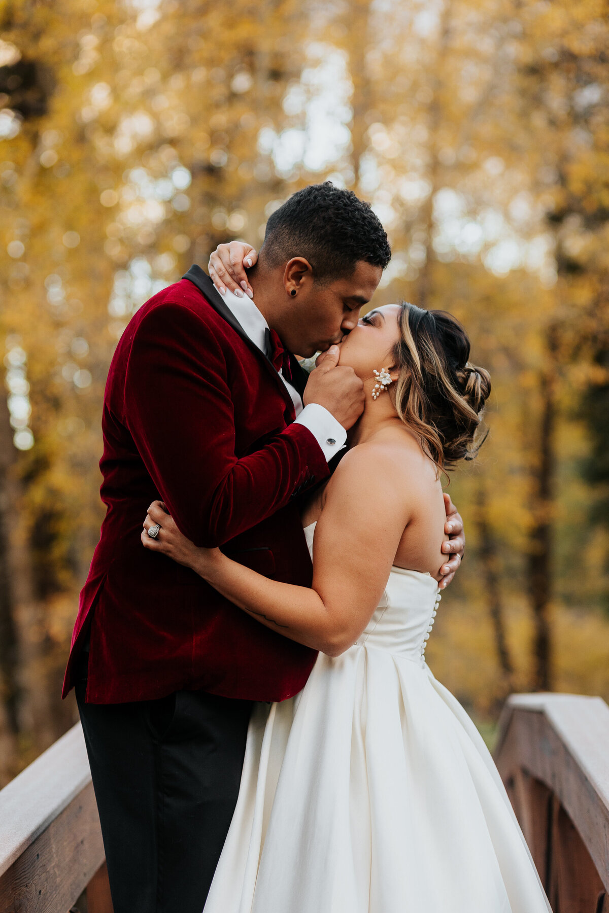 A bride and groom kiss at their wedding at Black Canyon Inn in Estes Park, Colorado.