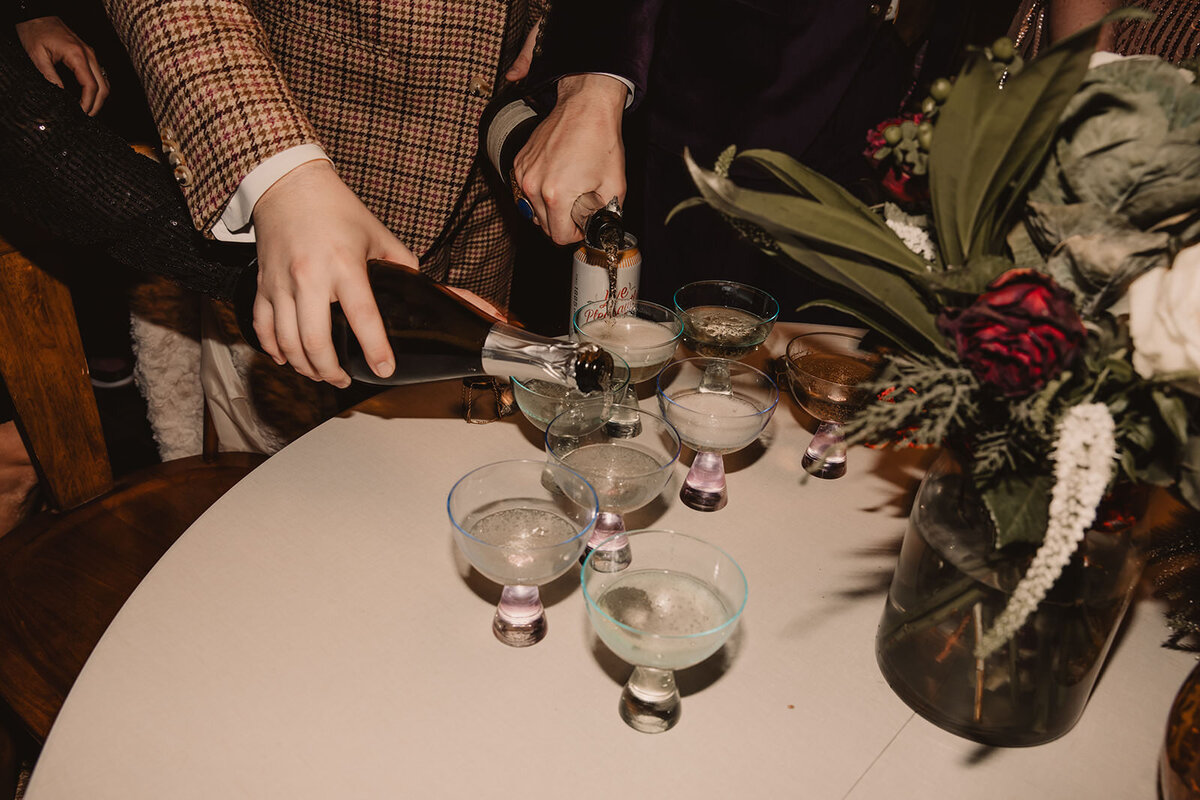 People pouring champagne into glasses