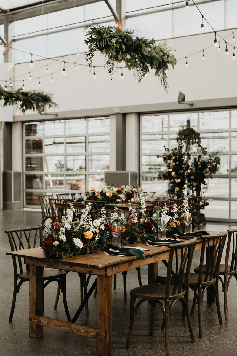 Vintage wedding decor and  jewel toned flowers at wedding reception.