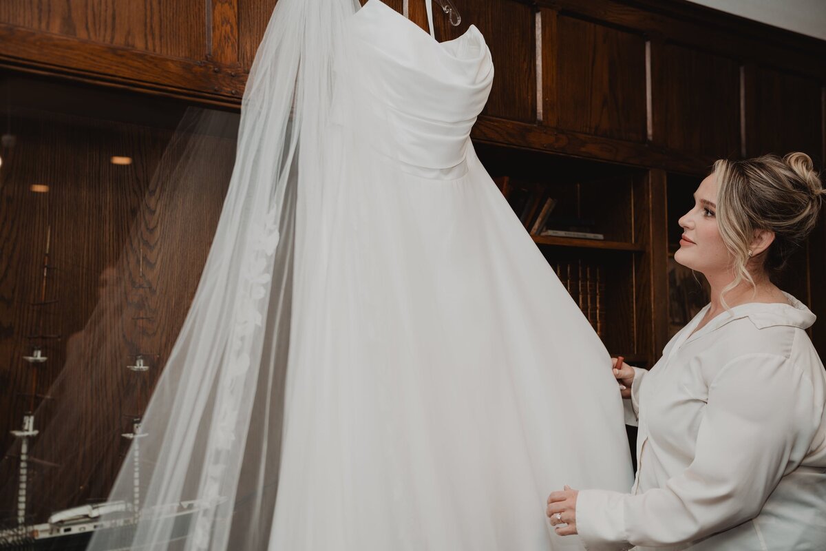 bride-looking-at-dress-hanging