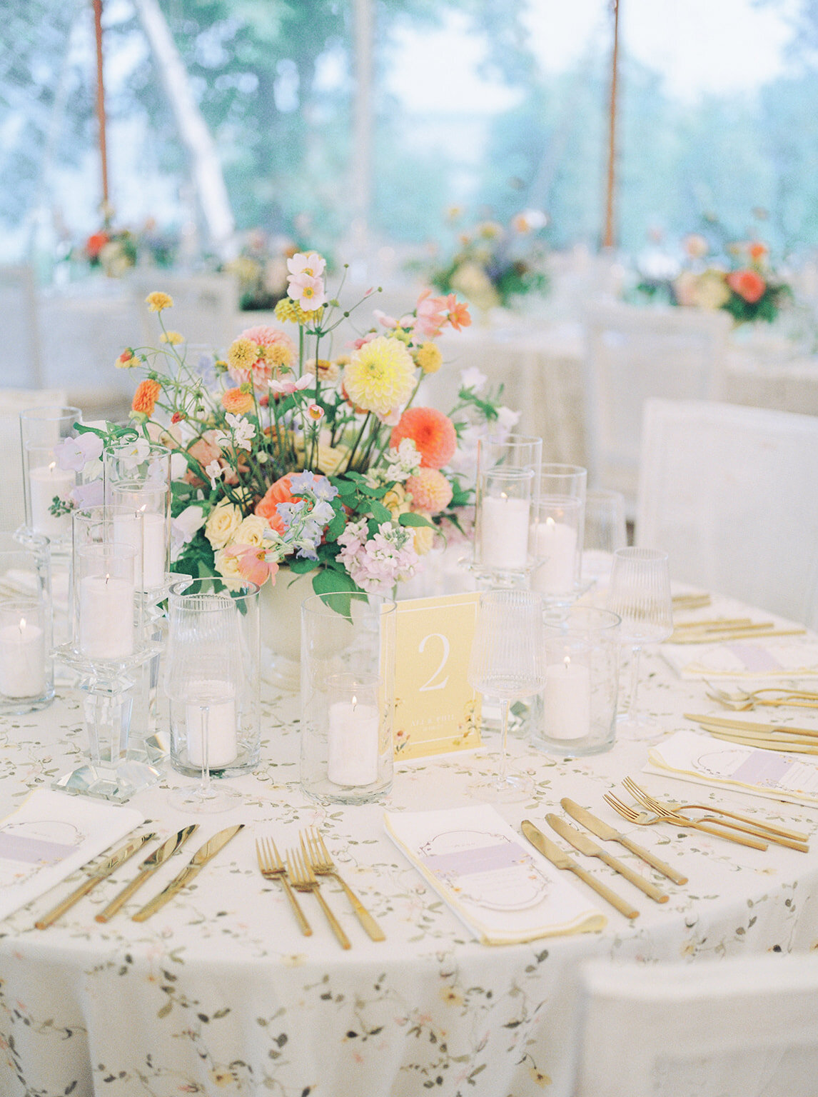 A wedding reception at the Forest and Stream Club featuring pastel garden floral centrepieces. 