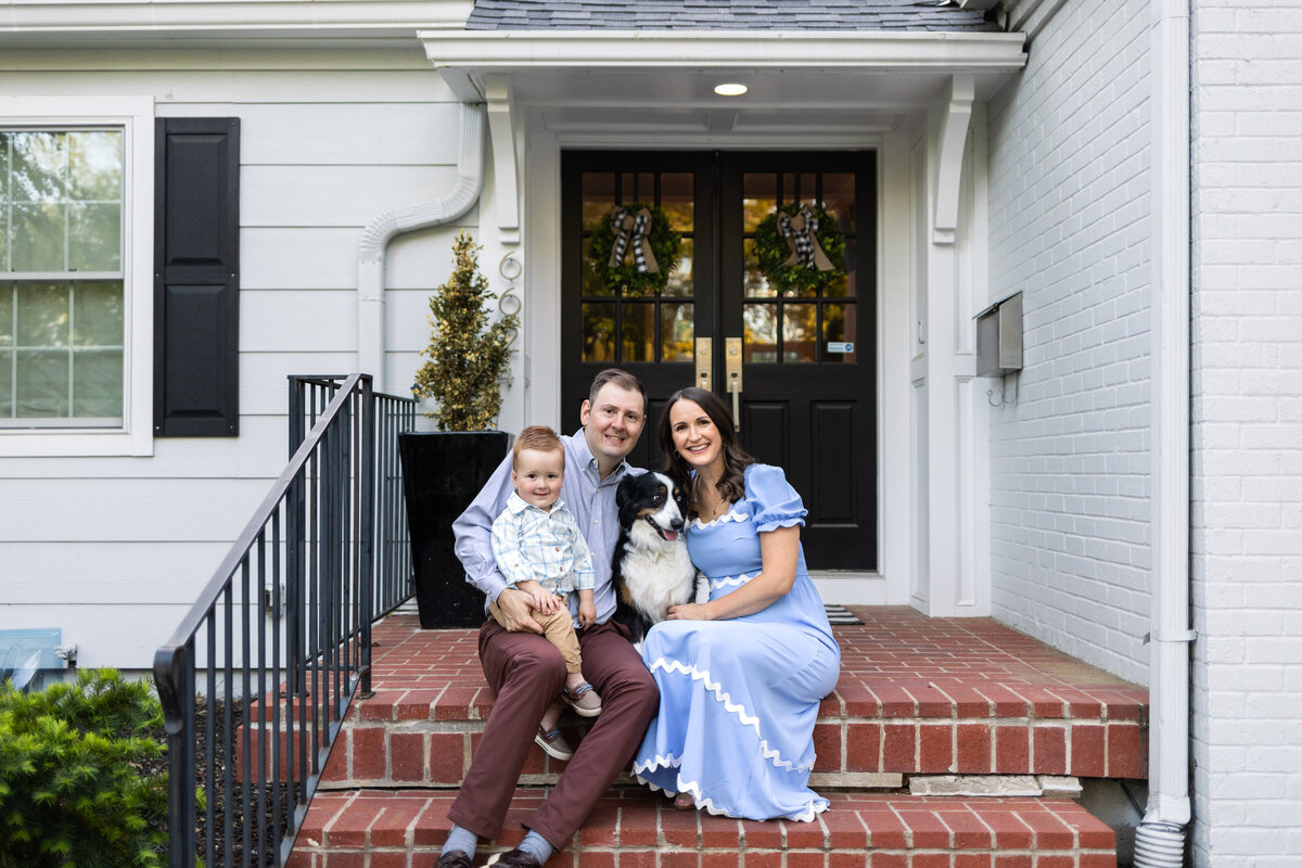 Kansas_City_Family_Photography_family_on_brick_porch_at_home_smiling_with_dog-6