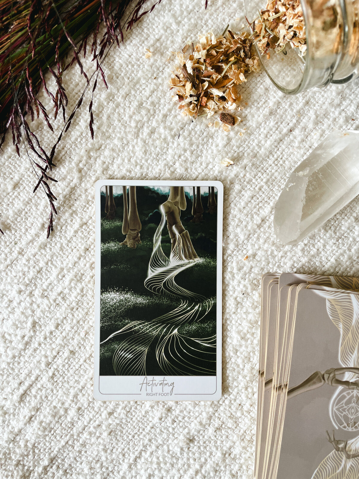 Close up of the "Activating" Oracle Card which corresponds to the Right Foot showing the feet of a skeleton walking through the forest and lines radiating from the right foot