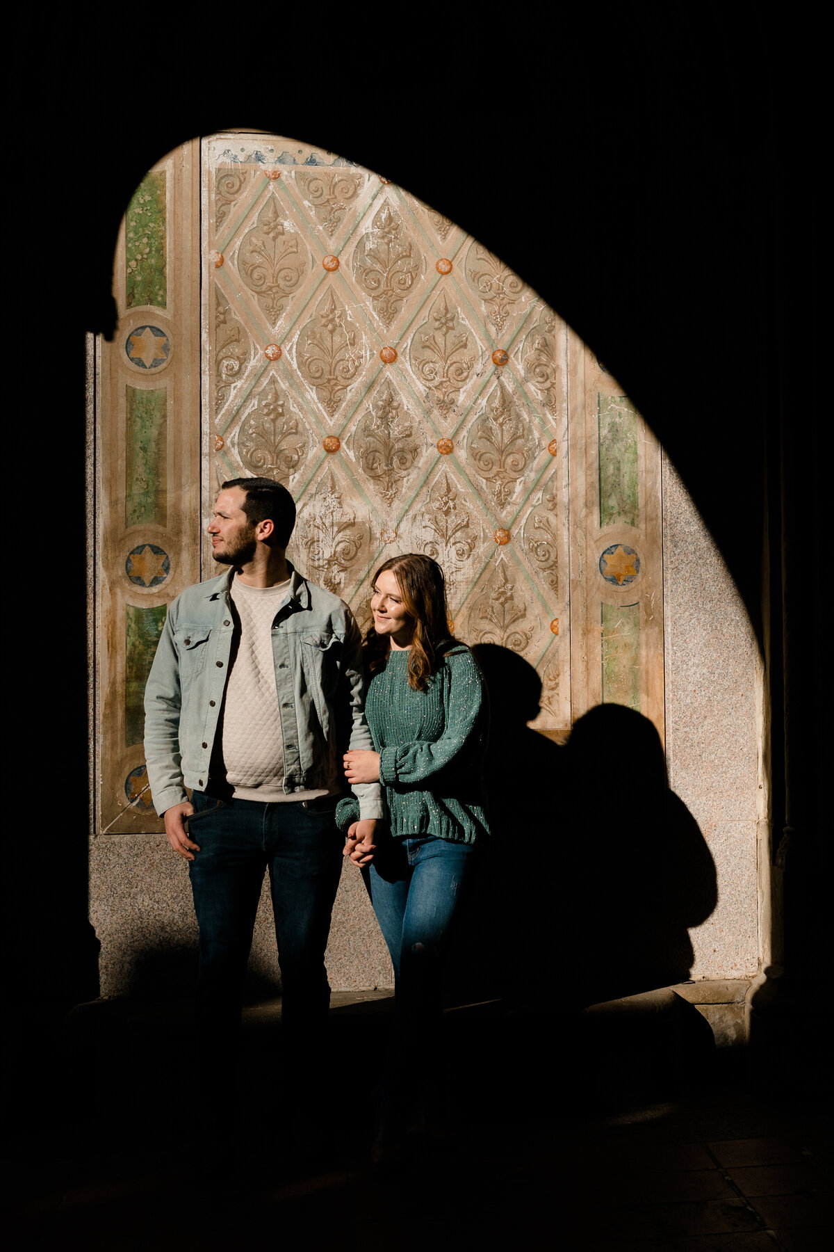 man and woman standing together in a patch of light