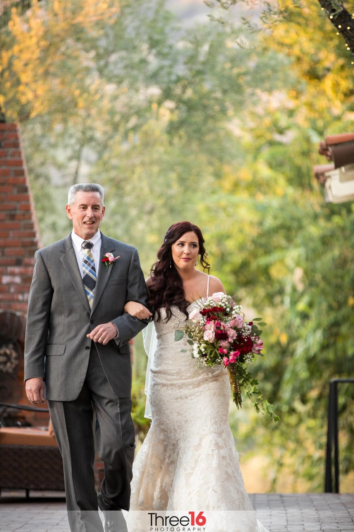 Father of the Bride escorts his daughter to the altar