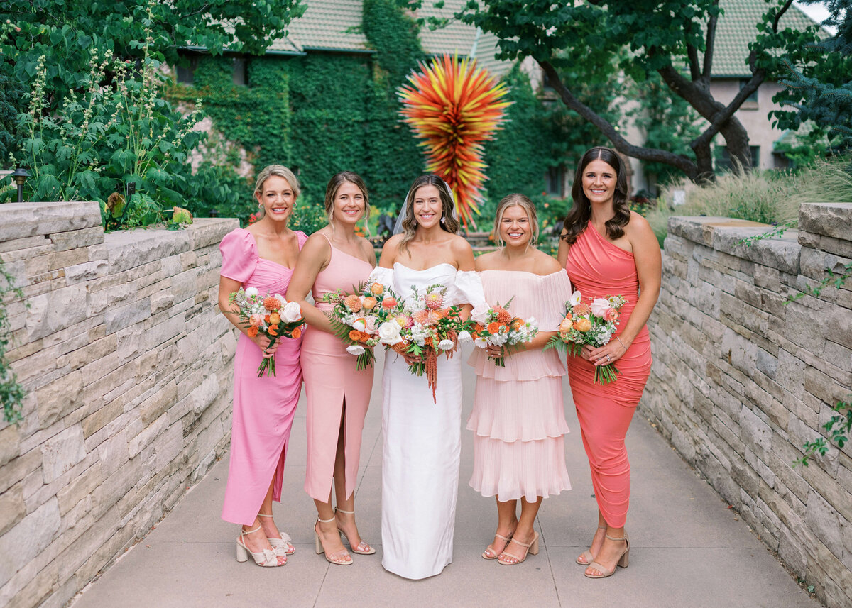 Virginia Wedding Photographer takes photo of bridesmaids in an array of pink dresses and their friend, the bride