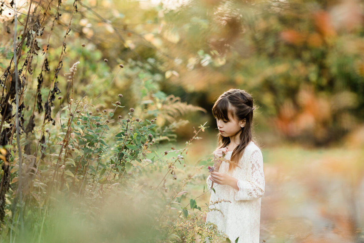 Artistic and dreamy photo of girl holding leaves in fall in Echo Lake Park, Mountainside, NJ