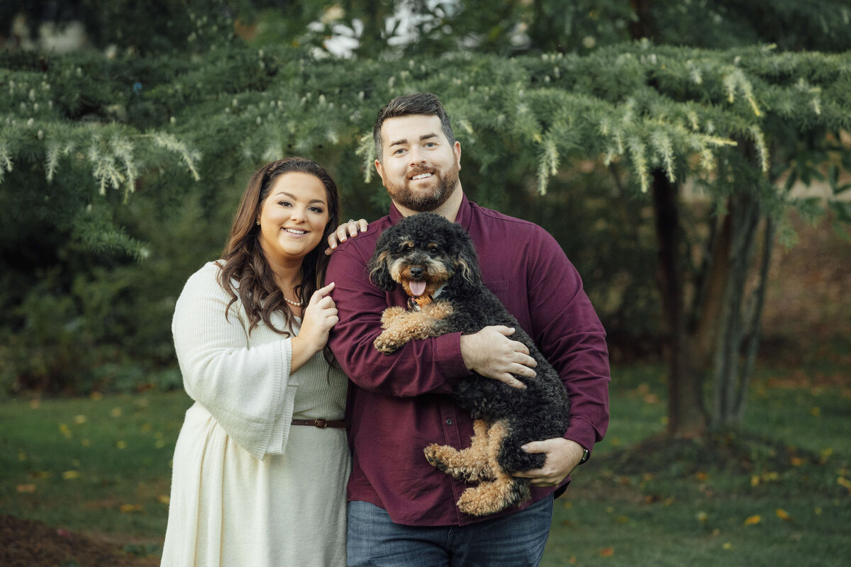 Couple with their dog during engagement photo at Grounds for Sculpture in Hamilton Township New Jersey
