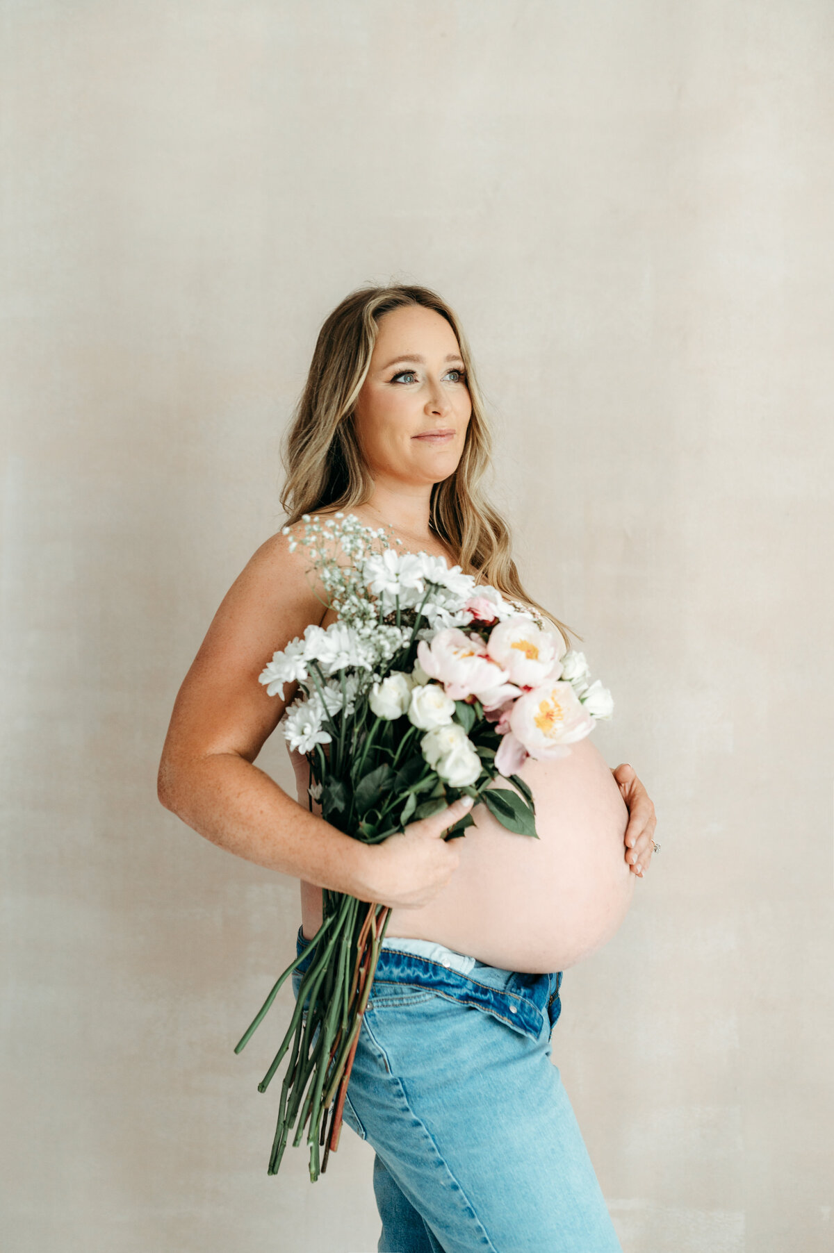 Pregnant Mom holding bouquet of flowers