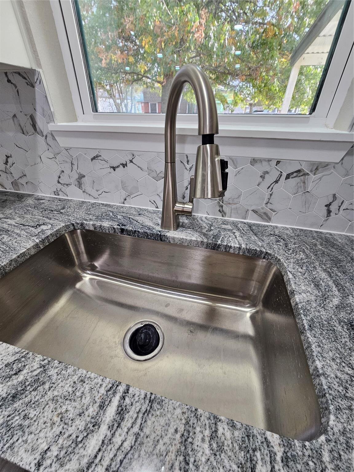 2 bed 1 bath home for sale in Gainesville, Texas - Kitchen sink and back splash