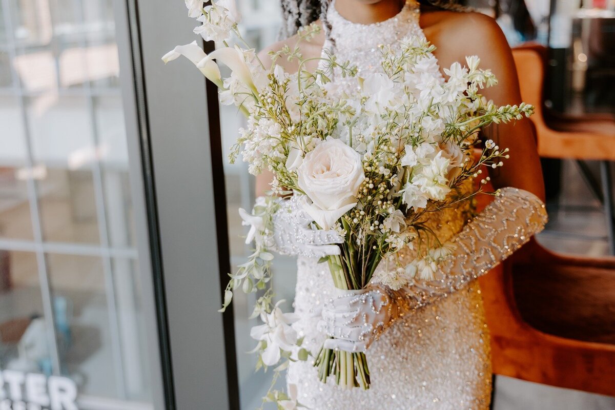 Bride holding her white wedding bouquet