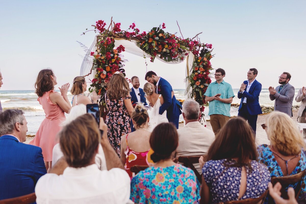 Bride and grooms first kiss at Blue Venado Seaside Riviera Maya wedding