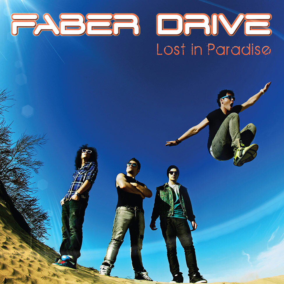Album Cover Faber Drive Title Lost In Paradise three band members standing in desert lead singer jumping in air with arms outstretched