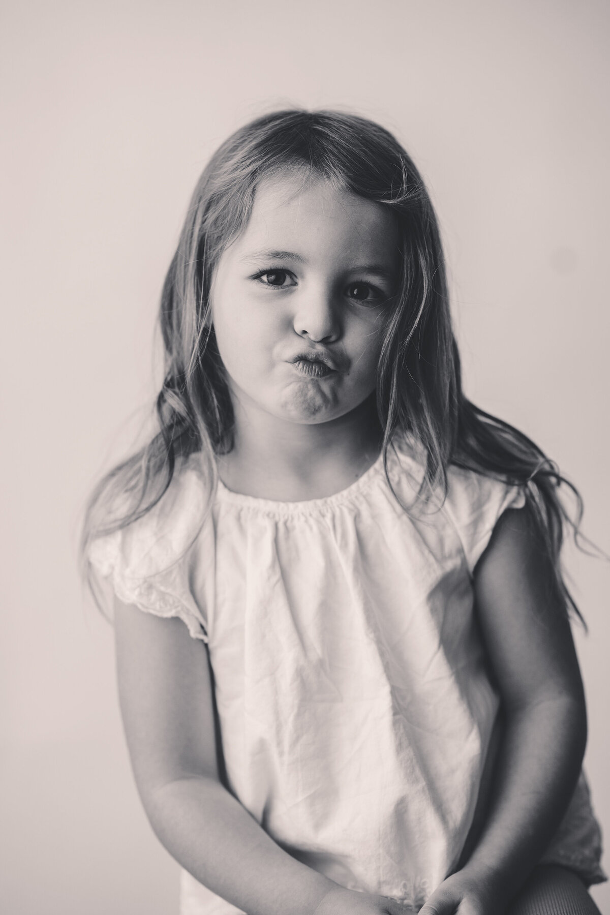 Little girl makes a silly face at the camera during Personality Portrait Session in Charleston, SC.