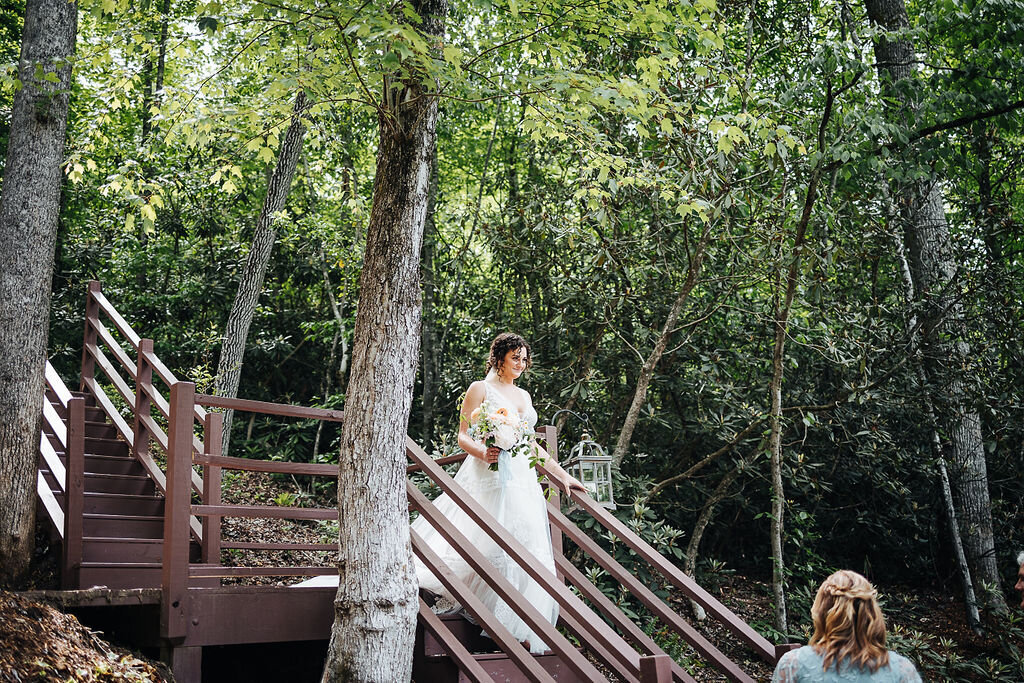 bride coming down wooden outdoor steps