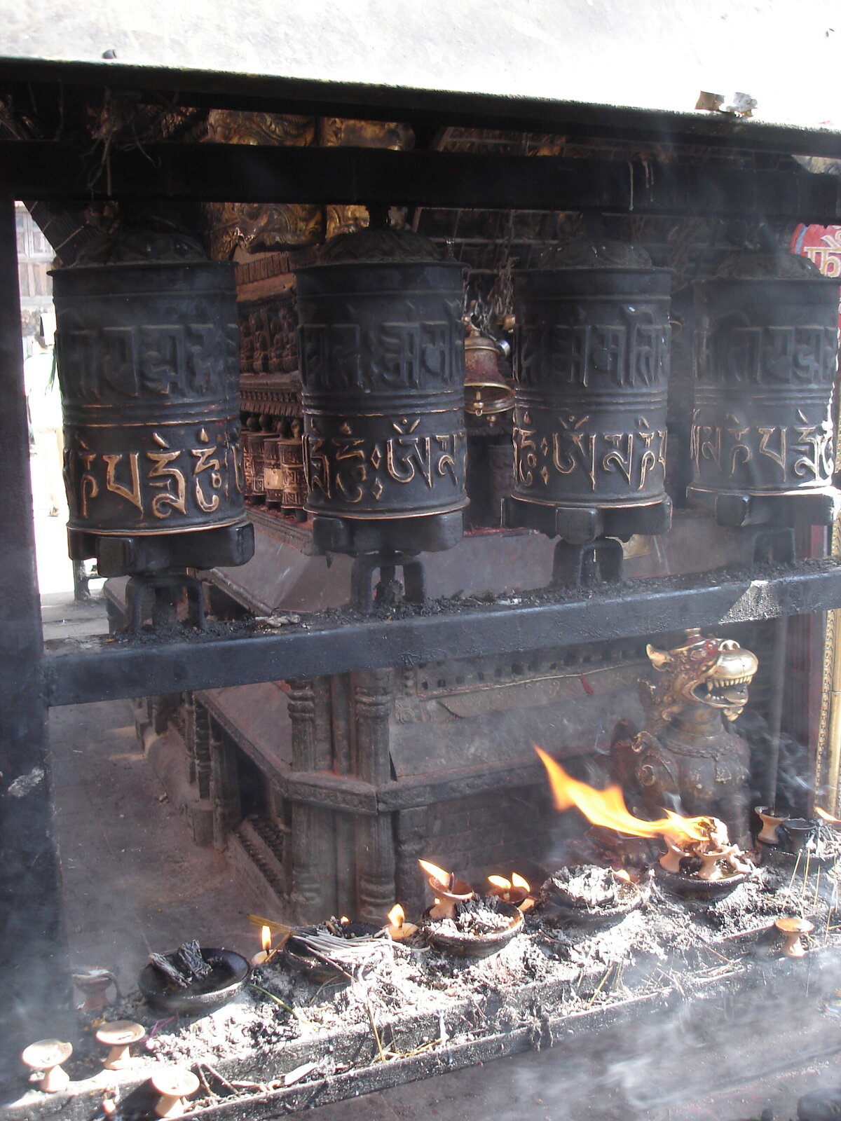 Prayer wheels, butter lamps and burning incense