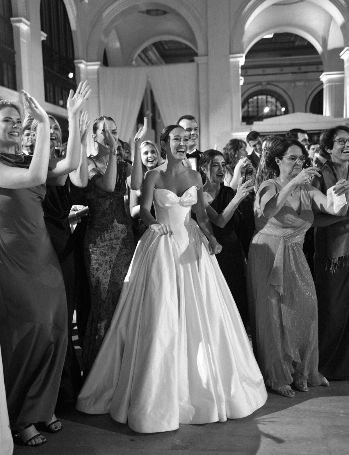 a bride laughs with her friends during dances at their unique Detroit wedding venue