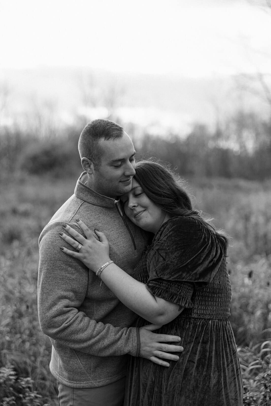 Woman resting head on man at  Finger Lakes Maternity session
