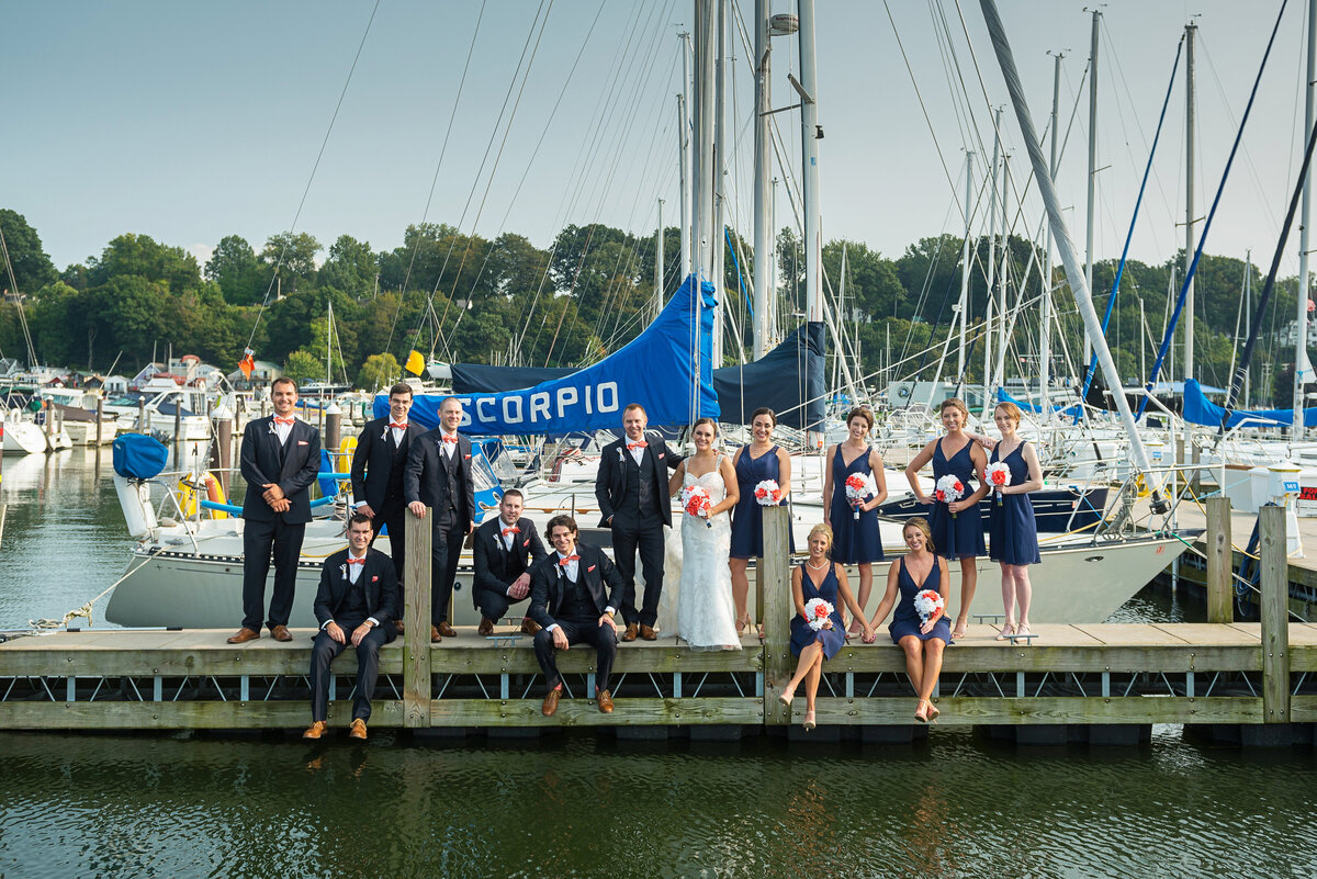 Bridal party posed by sailboat at Erie Yacht Club.