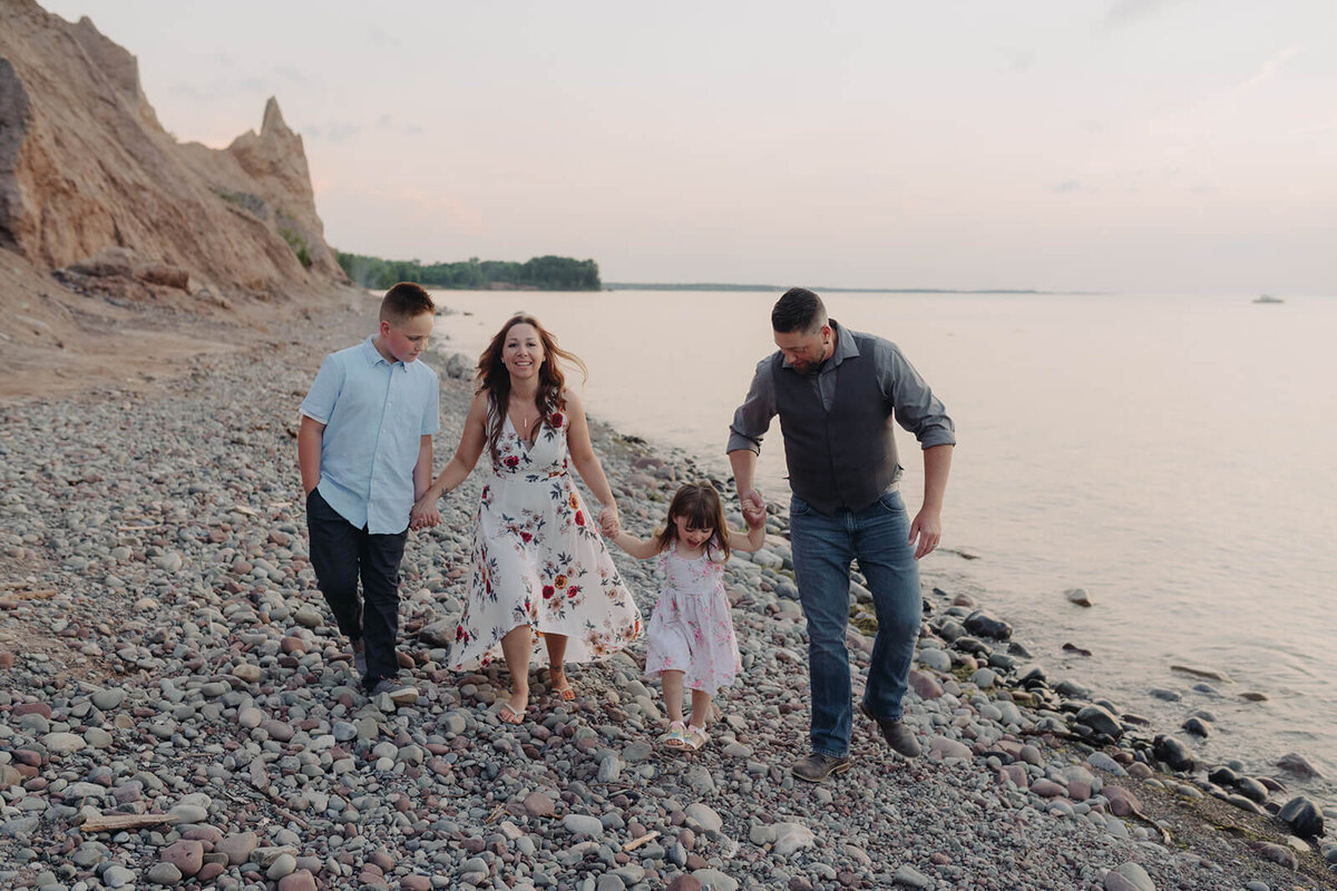 Family walking along the beach at sunset at Finger Lakes, NY