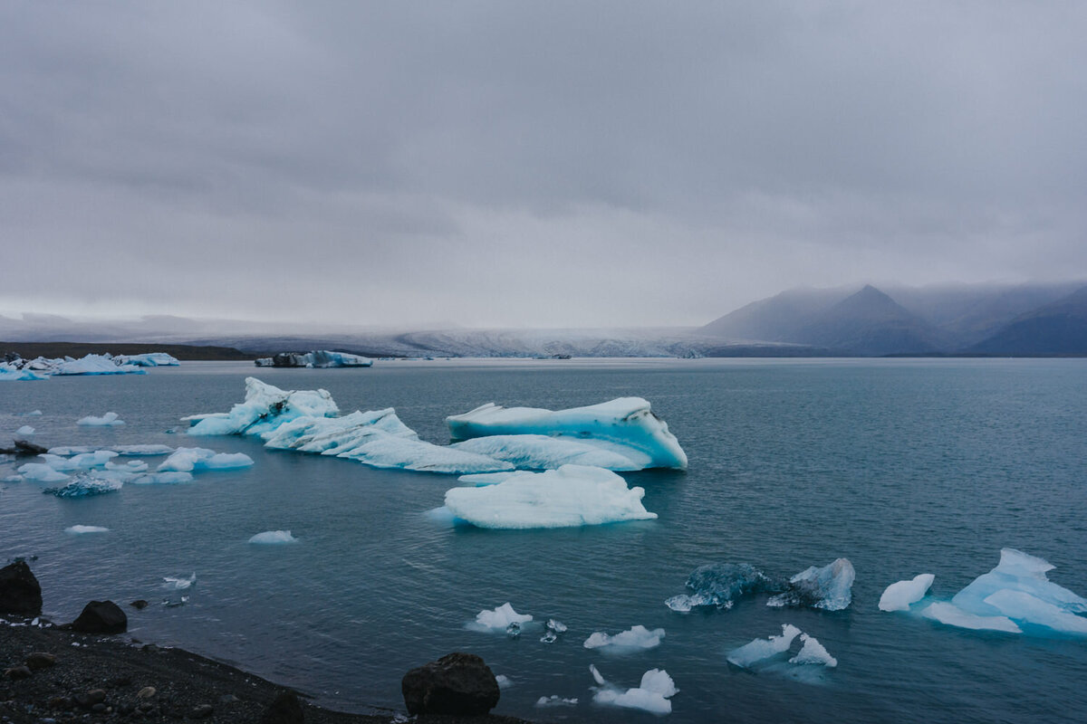 Icelandic glaciers sit in the bright blue water of the Black Sand Beaches 